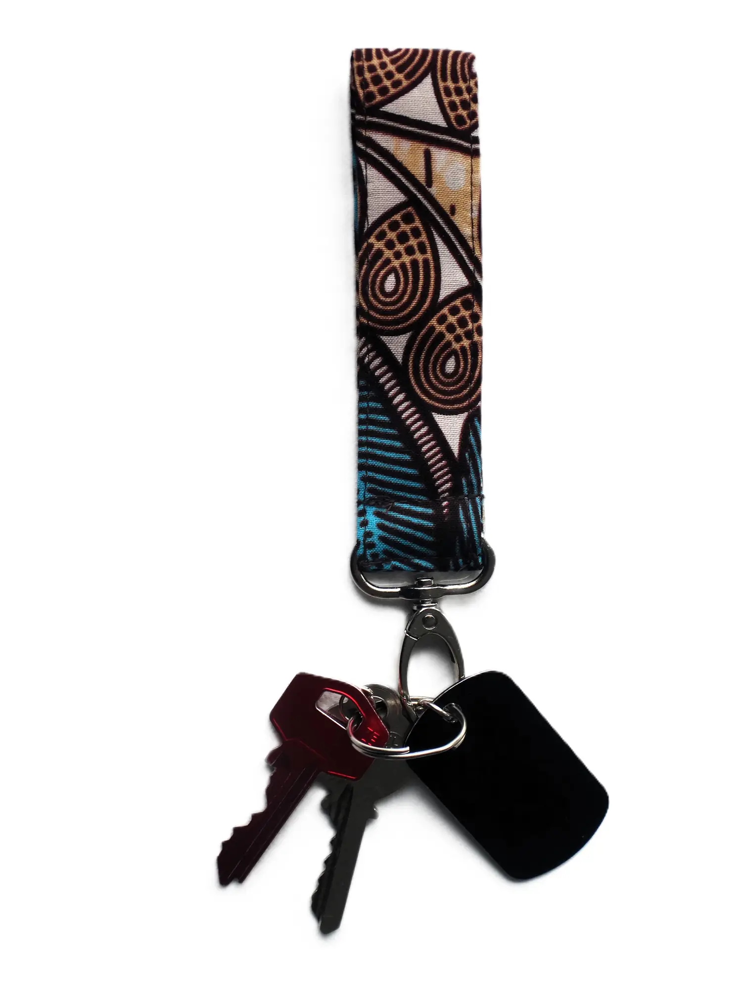 Llavero de cinta textil de la marca MARTIU con mosquetón metálico, diseñado con el estampado de la colección en azul y marrón, ideal para llevar las llaves con un toque de estilo artesanal de marca.